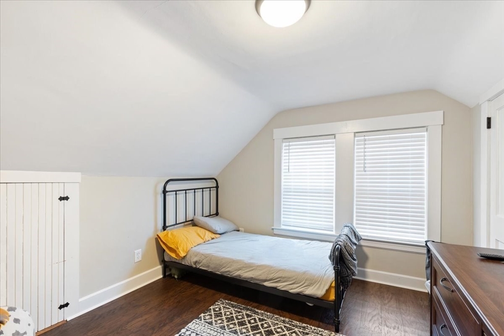 64 Parker Street Maynard, MA 01754 - Photo 25 of 39 a bedroom with a bed wooden floor and window