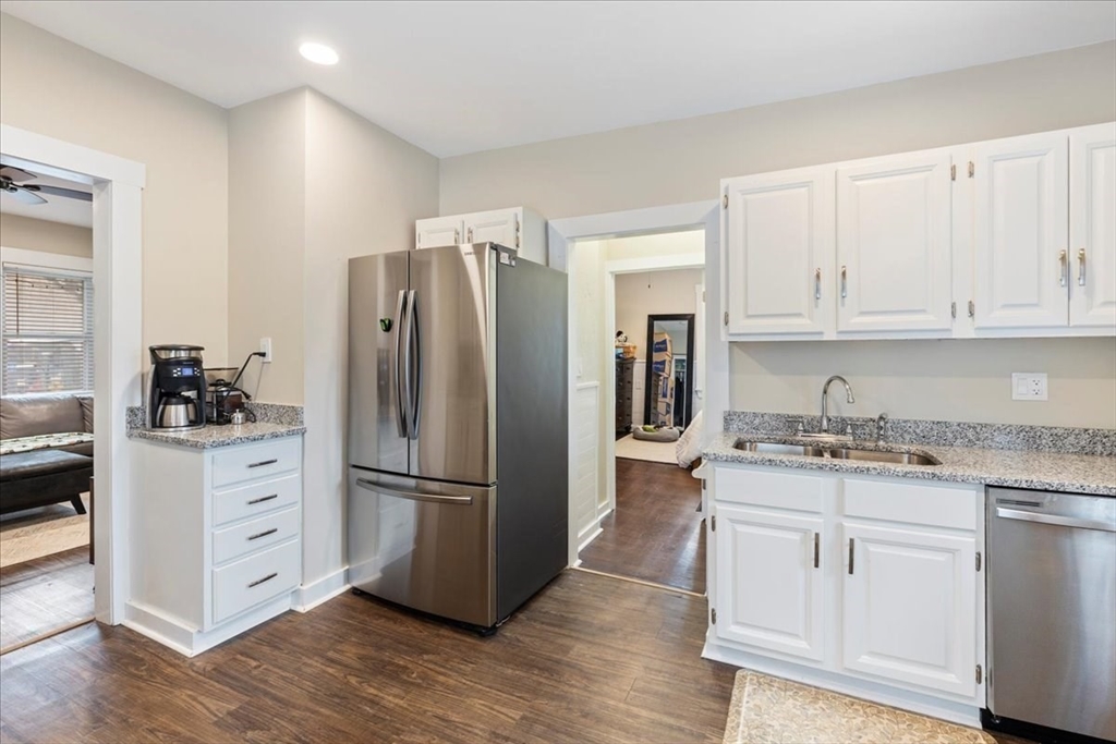 64 Parker Street Maynard, MA 01754 - Photo 4 of 39 a kitchen with white cabinets and stainless steel appliances