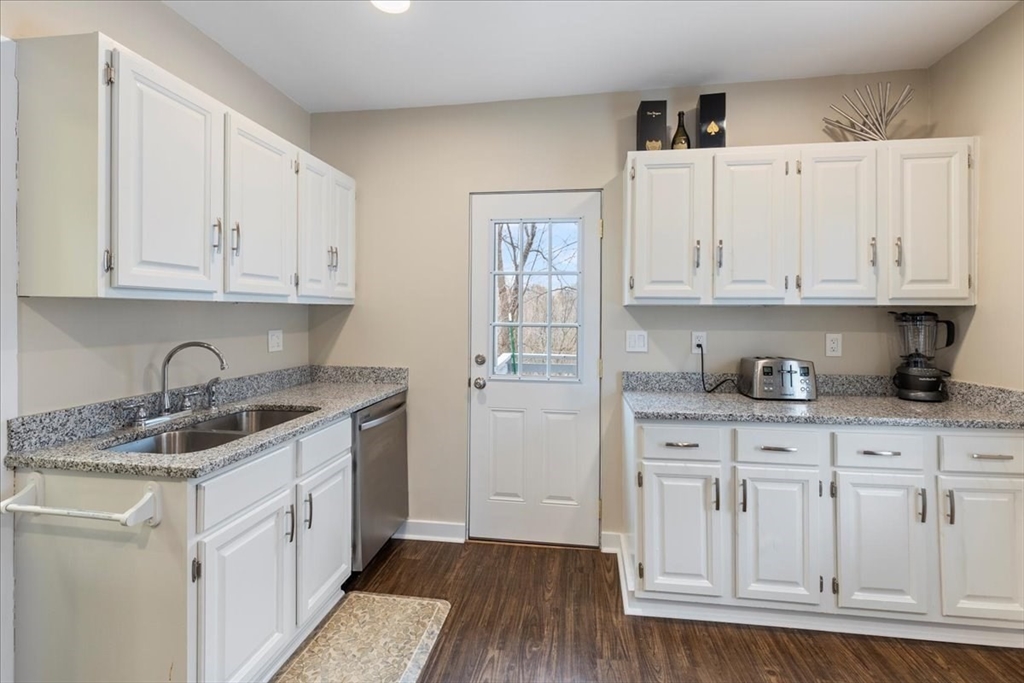 64 Parker Street Maynard, MA 01754 - Photo 5 of 39 a kitchen with stainless steel appliances granite countertop a sink and dishwasher with white cabinets