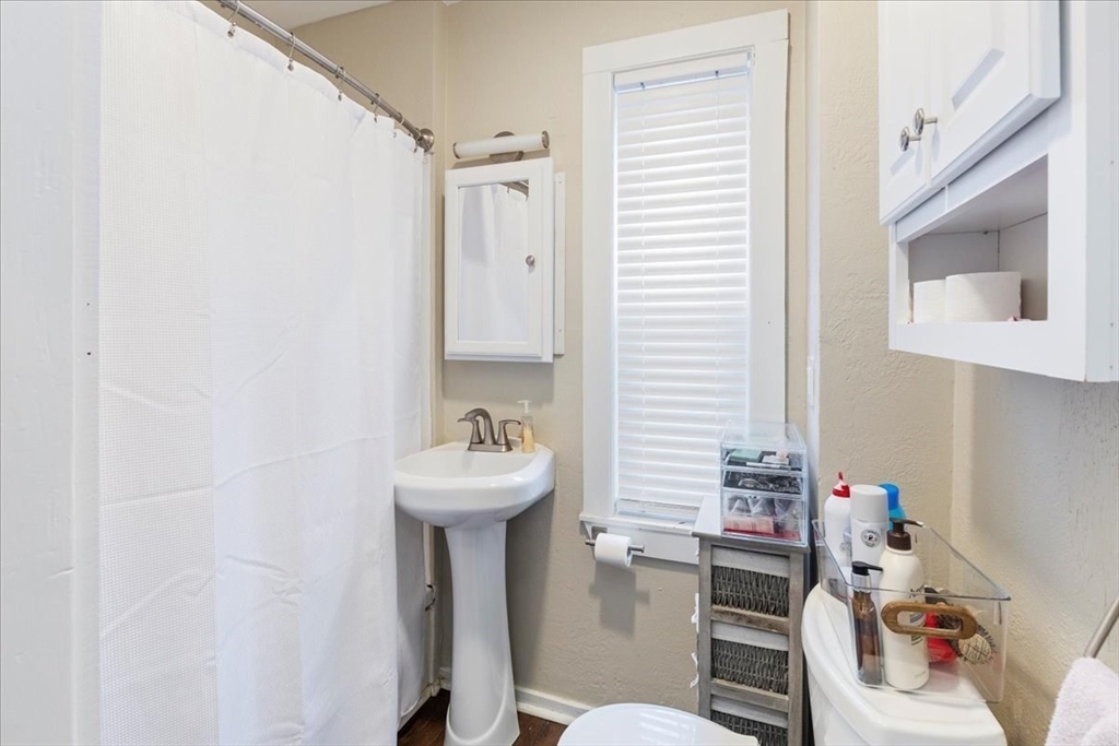 64 Parker Street Maynard, MA 01754 - Photo 8 of 39 a bathroom with a sink toilet and mirror