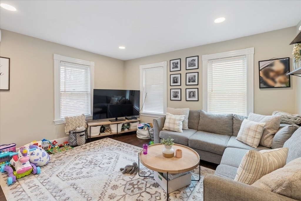 64 Parker Street Maynard, MA 01754 - Photo 10 of 39 a living room with furniture and a flat screen tv