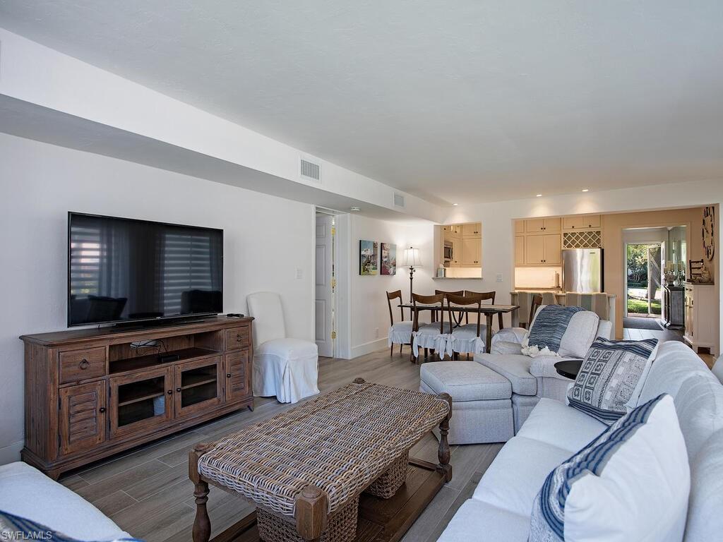 271 1st Avenue South Naples, FL 34102 - Photo 6 of 14 a living room with furniture and a flat screen tv