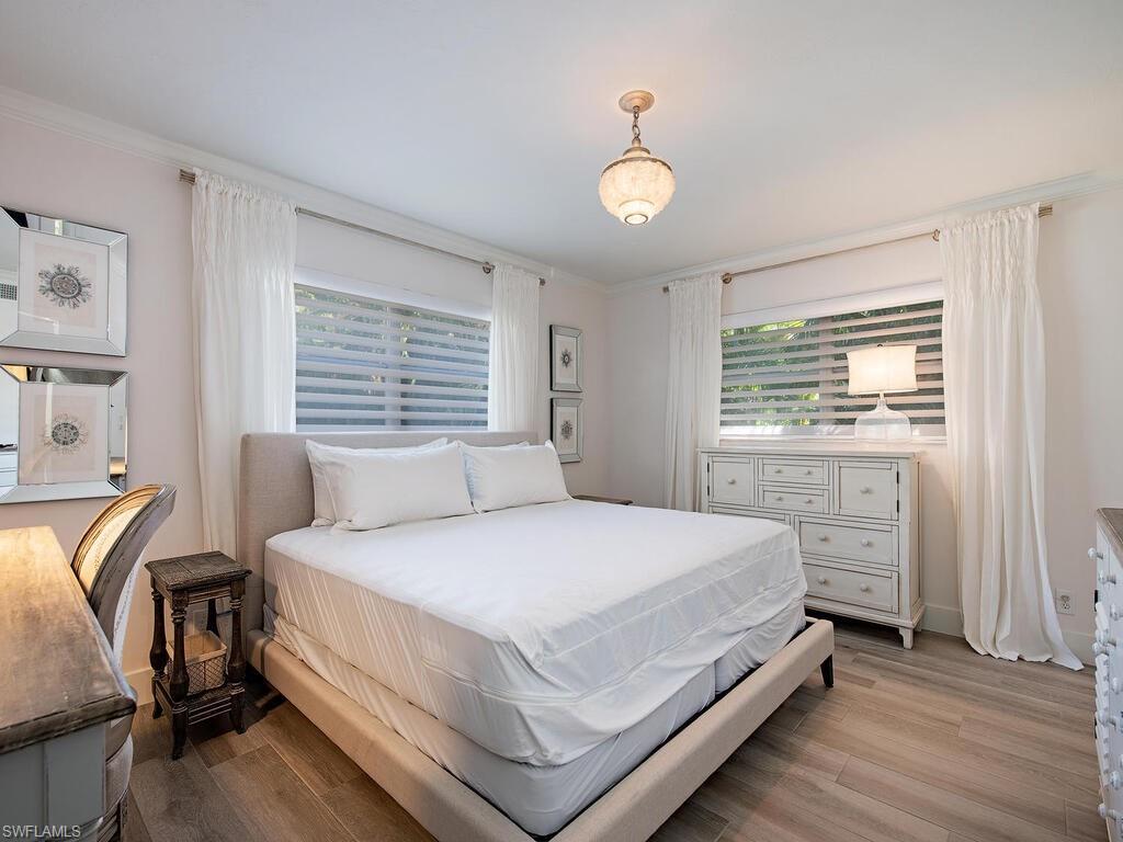 271 1st Avenue South Naples, FL 34102 - Photo 9 of 14 a bedroom with a bed and a window