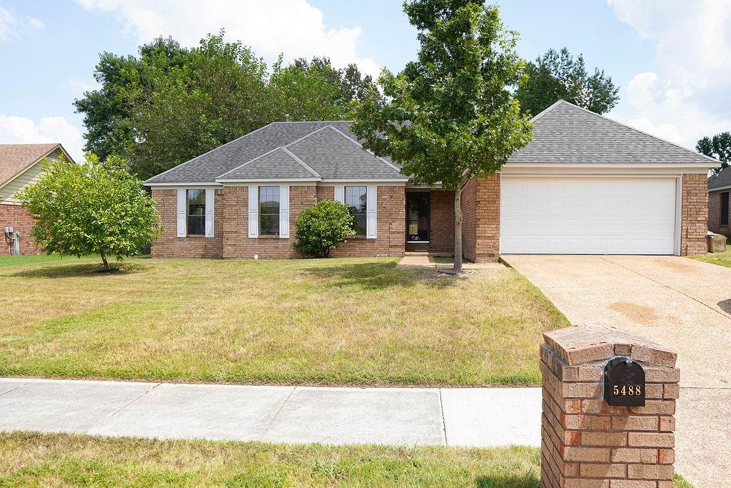 5488 Ross Road Memphis, TN 38141 - Photo 1 of 18 a front view of a house with a yard and trees