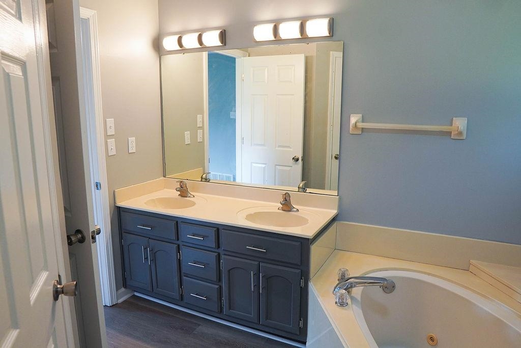 5488 Ross Road Memphis, TN 38141 - Photo 14 of 18 a bathroom with a tub sink and mirror