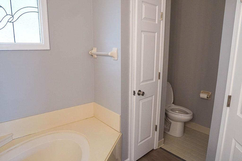 5488 Ross Road Memphis, TN 38141 - Photo 15 of 18 a bathroom with a toilet and a sink