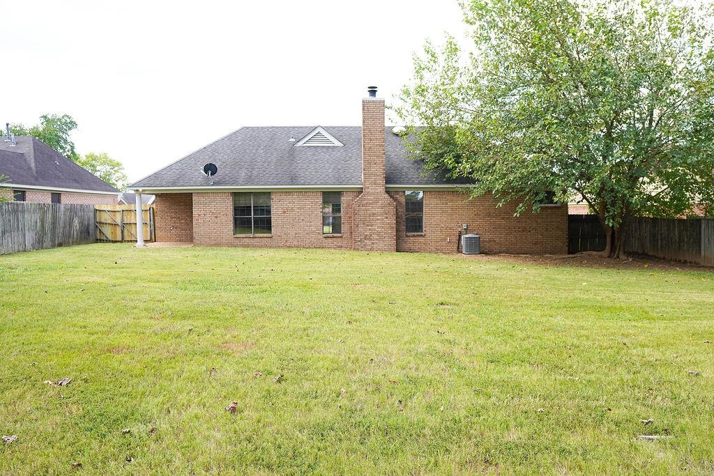 5488 Ross Road Memphis, TN 38141 - Photo 16 of 18 a view of a house with a yard and a large tree