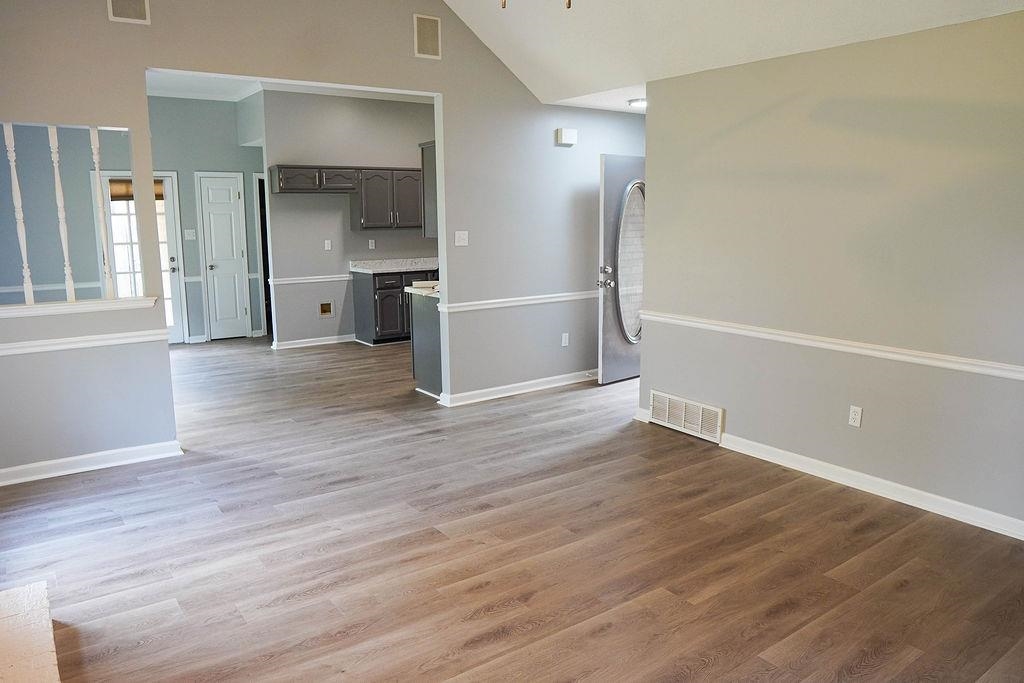 5488 Ross Road Memphis, TN 38141 - Photo 3 of 18 an empty room with wooden floor and windows