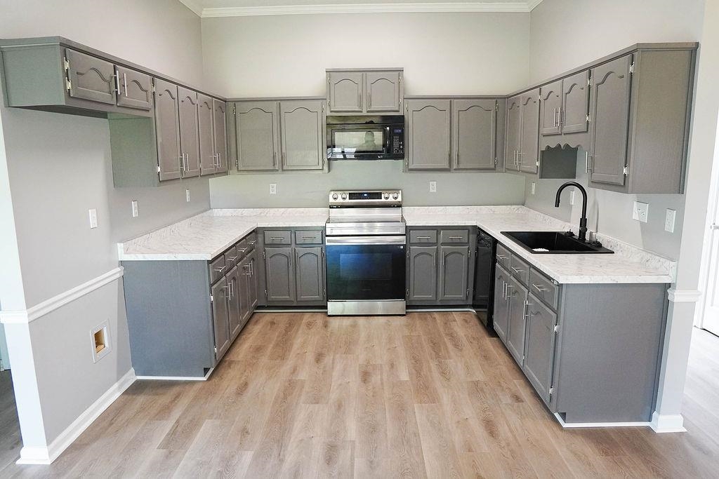5488 Ross Road Memphis, TN 38141 - Photo 5 of 18 a kitchen with stainless steel appliances granite countertop a sink stove and refrigerator