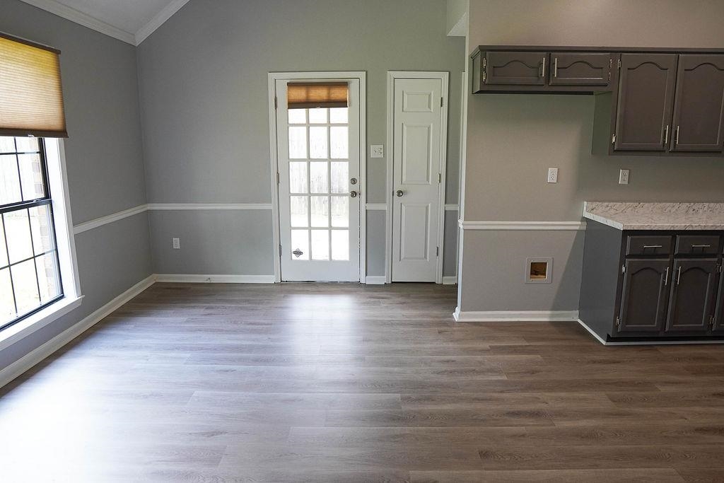 5488 Ross Road Memphis, TN 38141 - Photo 7 of 18 an empty room with wooden floor and windows