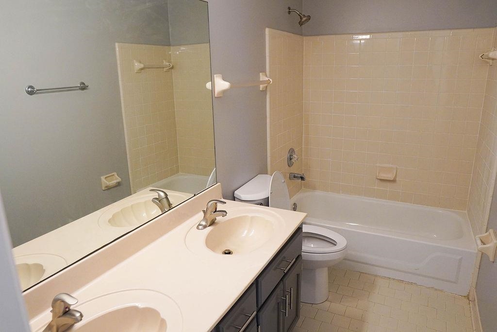 5488 Ross Road Memphis, TN 38141 - Photo 8 of 18 a bathroom with a sink a toilet and shower