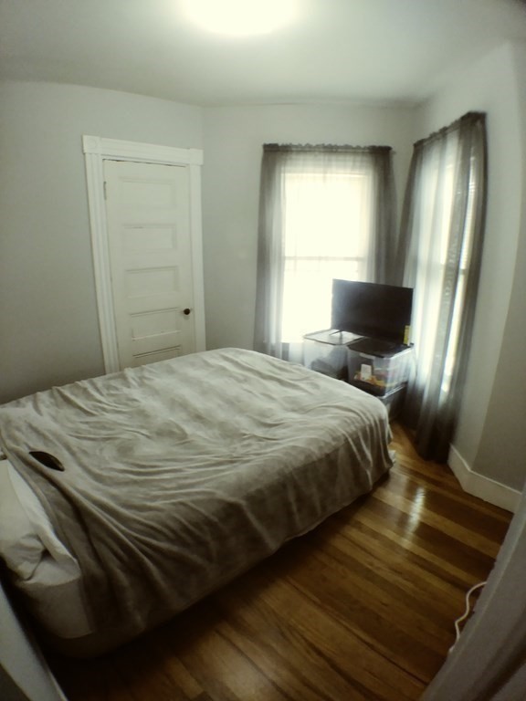 74 Sydney Street, Unit 2 Boston, MA 02125 - Photo 7 of 28 a bedroom with a bed and a mirror