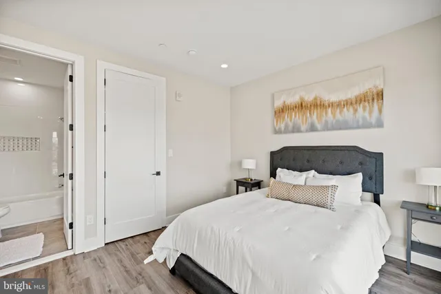 a bedroom with a bed and a large mirror