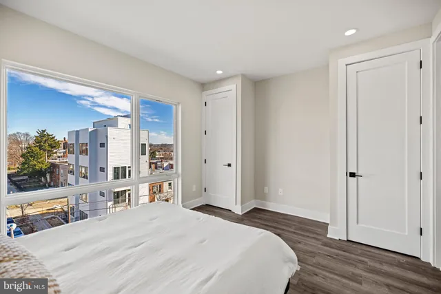 a bedroom with a large bed and a large window