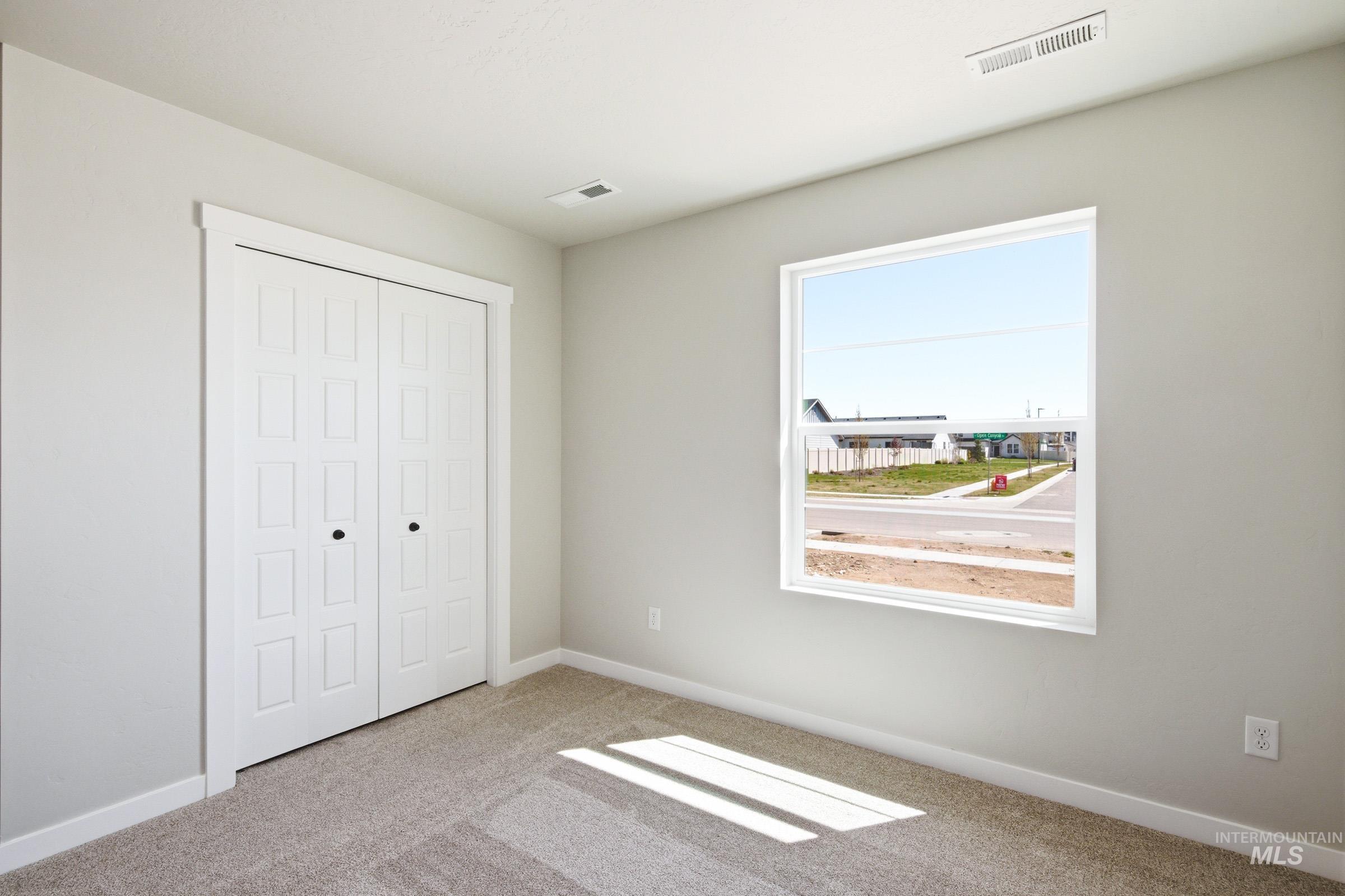 12805 Decatur Street Nampa, ID 83651 - Photo 12 of 20 Neutral-toned walls complement the carpeted flooring and white trim