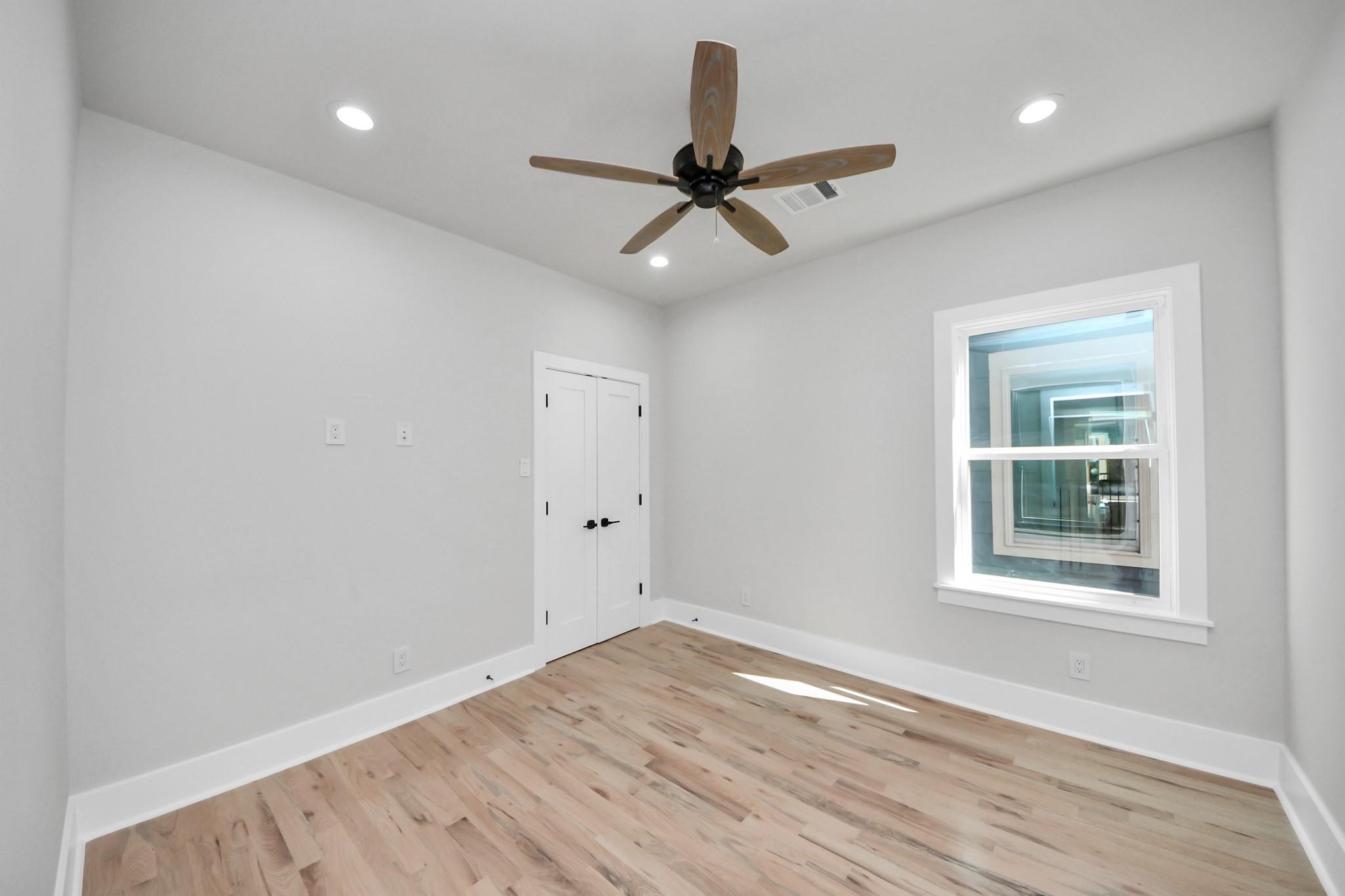 6320 Milwee Street, Unit B Houston, TX 77092 - Photo 16 of 30 a view of an empty room with wooden floor and a window