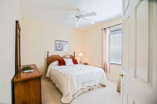 a bedroom with a bed and a ceiling fan