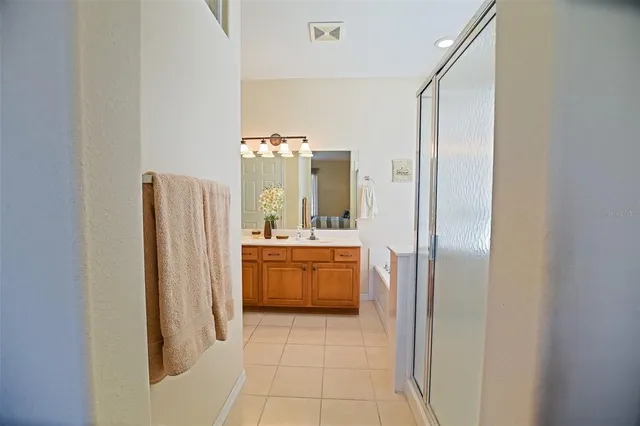 a bathroom with a glass door shower and a sink