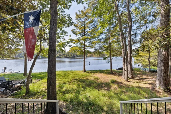 a view of a patio with a table chairs and a backyard