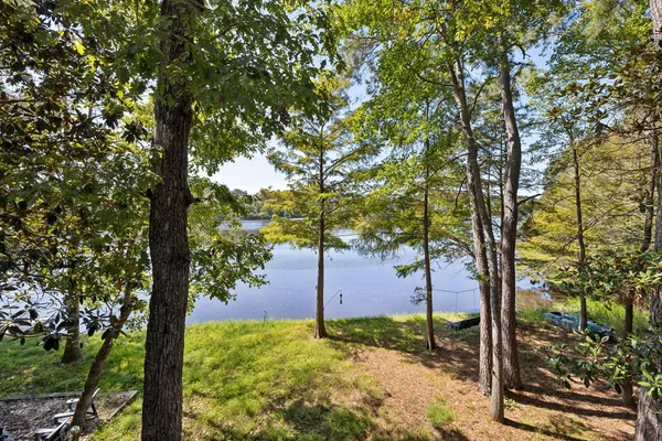 a wooden pier with boats in a lake