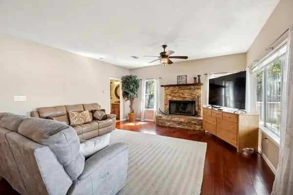a living room with furniture a flat screen tv and a fireplace