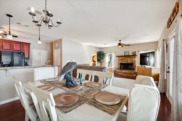 a kitchen with stainless steel appliances granite countertop a sink a stove a refrigerator a washer dryer and a cabinets