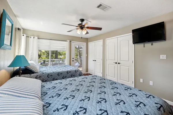 a bedroom with two large bed and a window