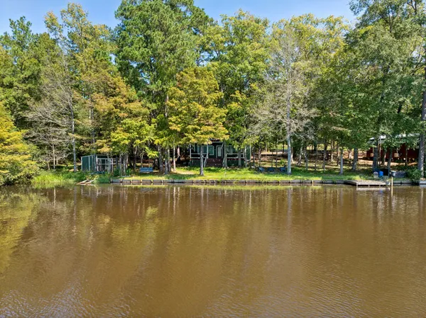 an aerial view of lake and residential houses with outdoor space