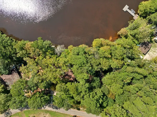 an aerial view of a houses with ocean view