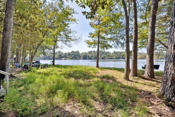 a view of yard with tree and wooden fence