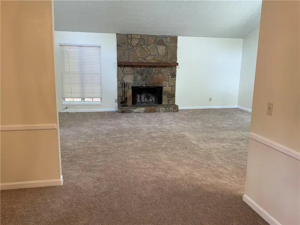 a view of an empty room with a fireplace