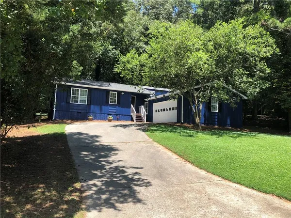 a front view of house with yard and green space