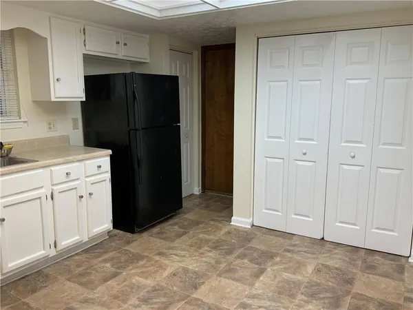 a kitchen with a refrigerator and a sink
