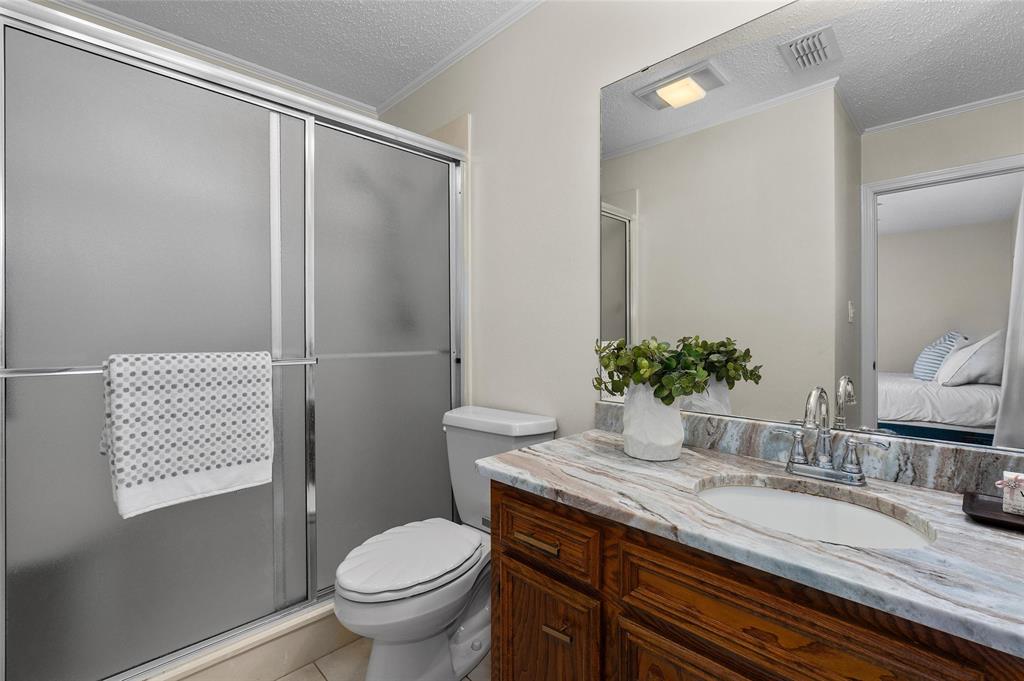 927 Stonewall-Preston Road Stonewall, LA 71078 - Photo 19 of 28 a bathroom with a granite countertop sink toilet and shower