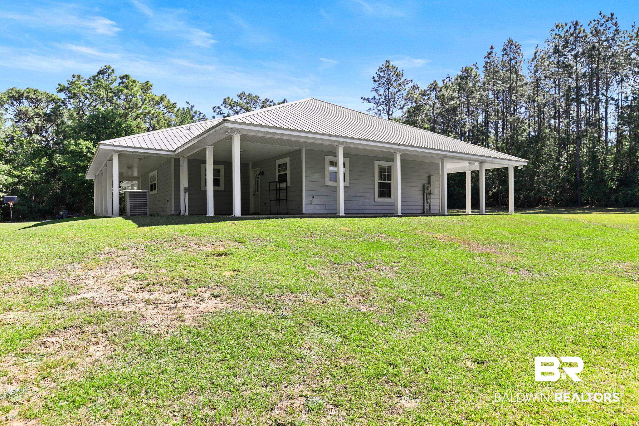 20219 Greek Cemetery Road Robertsdale, AL 36567 - Photo 9 of 41 Single-story residence featuring light gray siding and a metal roof