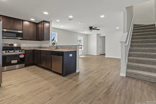 a kitchen with stainless steel appliances granite countertop a stove and a sink
