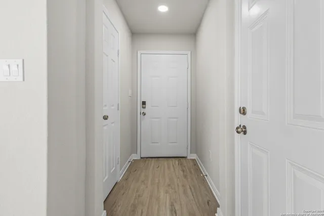 a view of a room with wooden floor