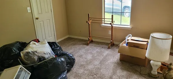 a bed sitting in a bedroom next to a window