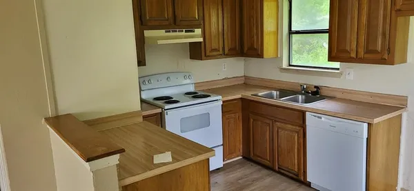 a kitchen that has a sink and a stove