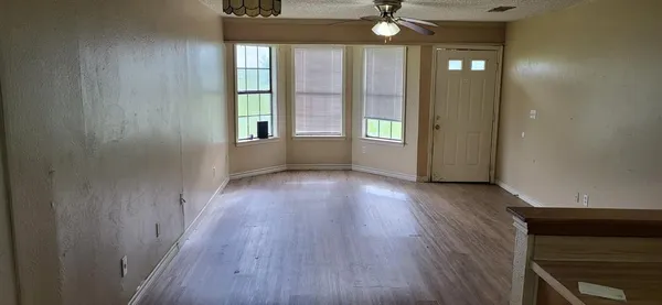 wooden floor in an empty room with a window