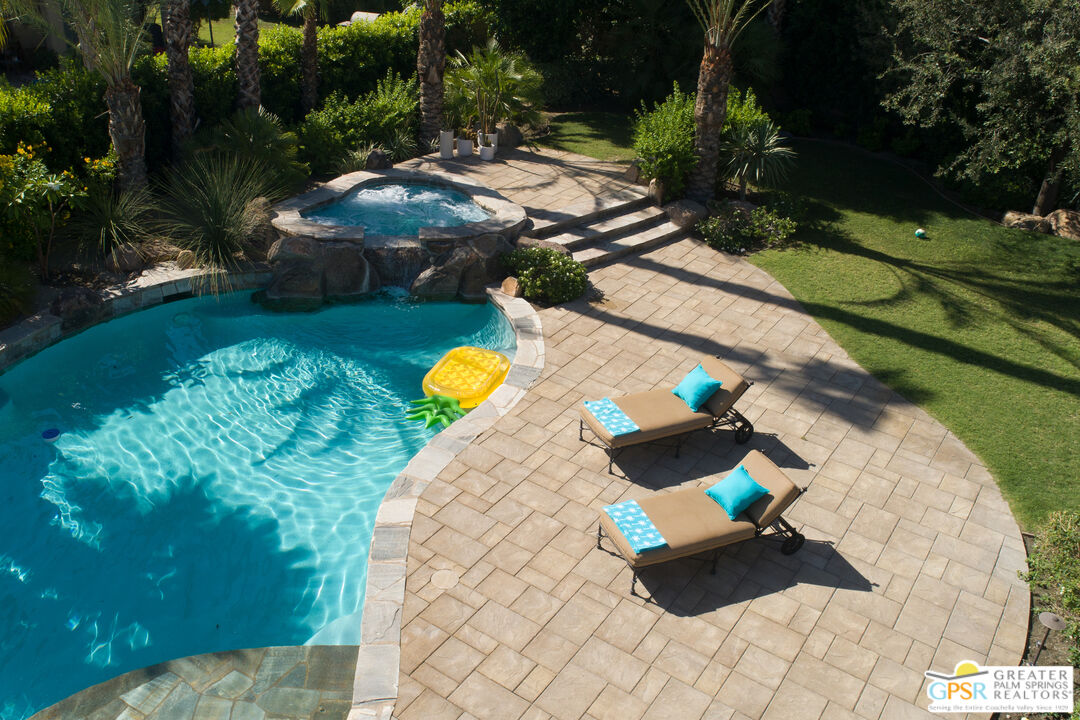 49880 Rancho San Felipe La Quinta, CA 92253 - Photo 30 of 47 a view of a swimming pool with a yard and outdoor seating