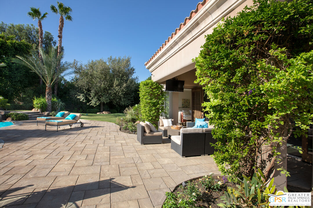 49880 Rancho San Felipe La Quinta, CA 92253 - Photo 33 of 47 a view of a patio with couches and table and chairs and potted plants