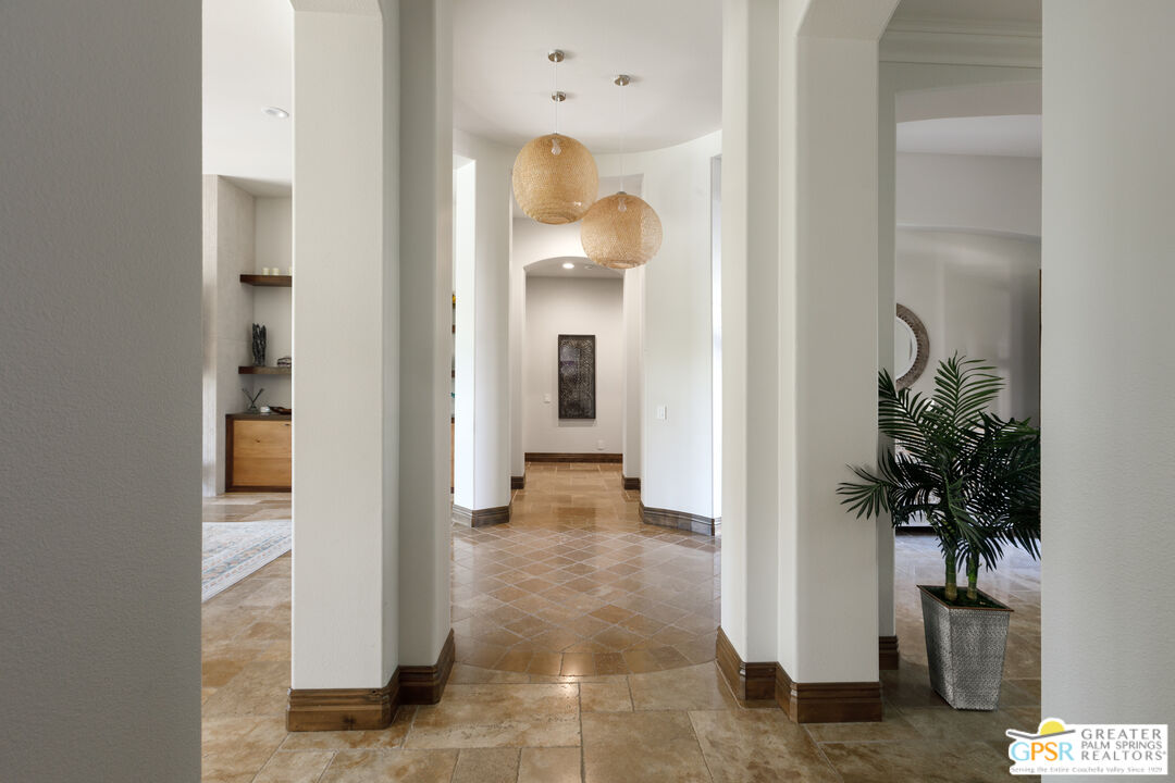 49880 Rancho San Felipe La Quinta, CA 92253 - Photo 8 of 47 a view of a hallway with paintings on the wall