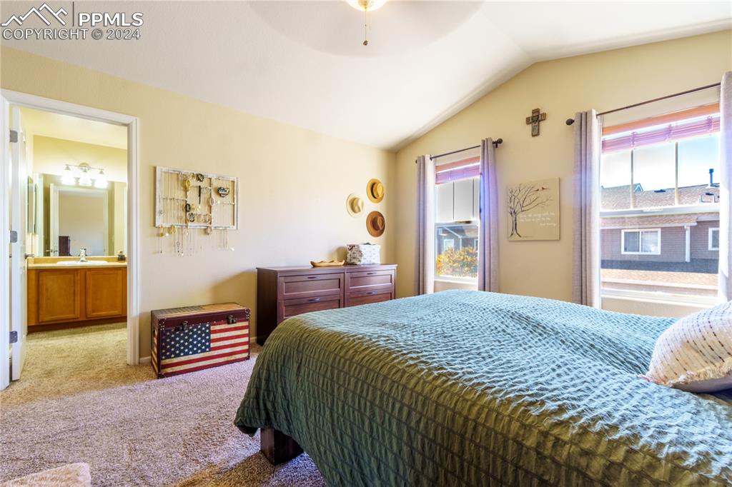7332 Sandy Springs Point Fountain, CO 80817 - Photo 13 of 28 a bedroom with a bed wooden floor and large window