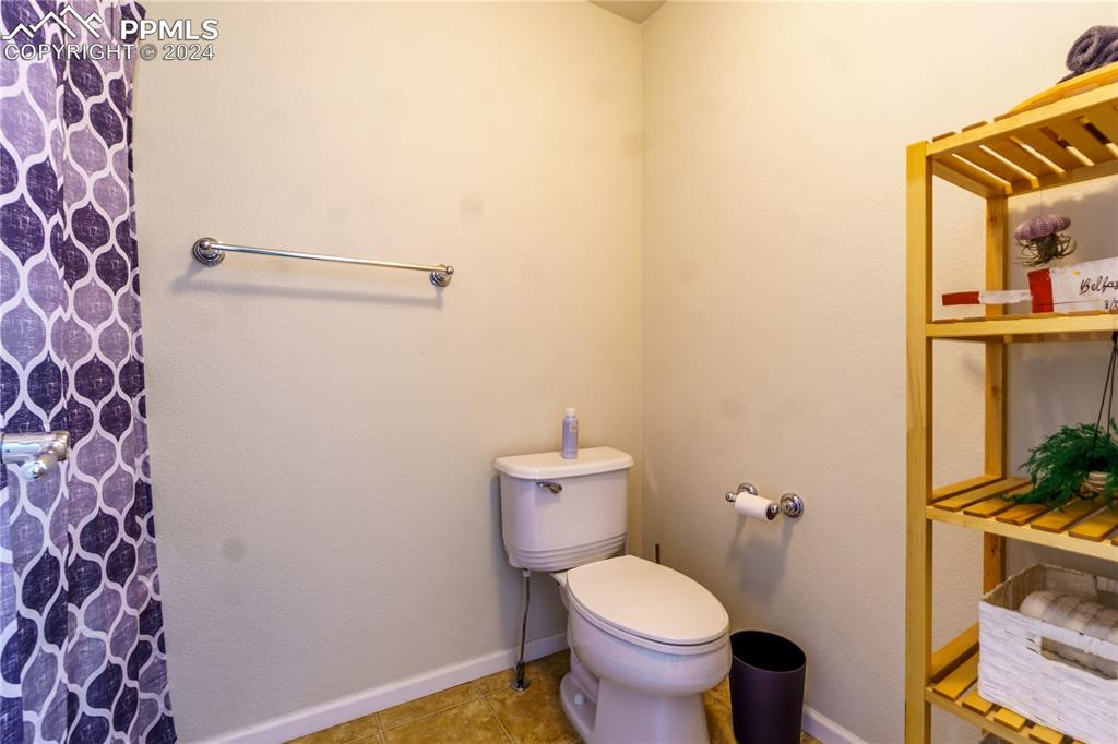 7332 Sandy Springs Point Fountain, CO 80817 - Photo 22 of 28 a bathroom with a toilet and a mirror