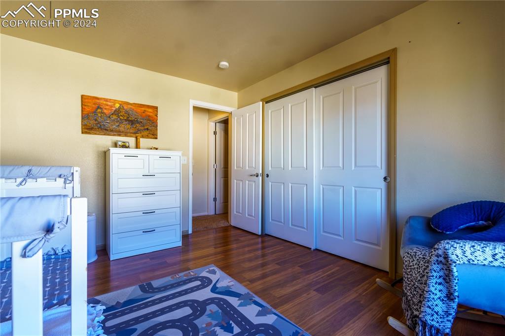7332 Sandy Springs Point Fountain, CO 80817 - Photo 25 of 28 a view of a bedroom with wooden floor