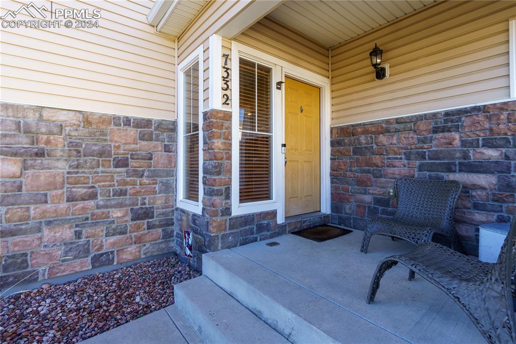 7332 Sandy Springs Point Fountain, CO 80817 - Photo 3 of 28 a brick building with a table and chairs in front of door