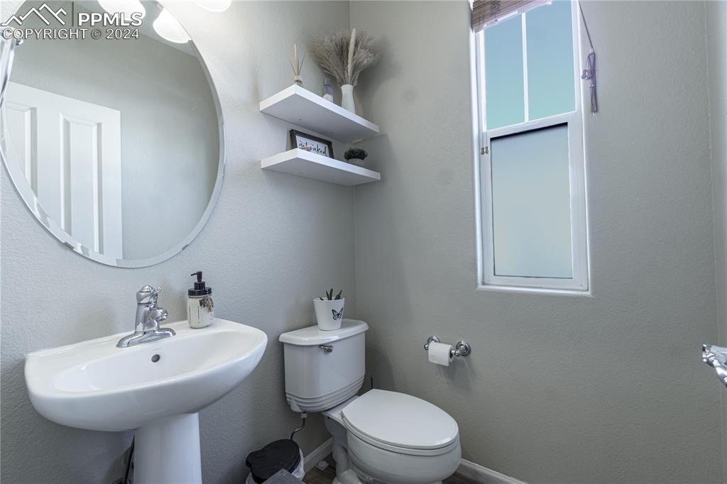 7332 Sandy Springs Point Fountain, CO 80817 - Photo 10 of 28 a bathroom with a toilet sink and mirror