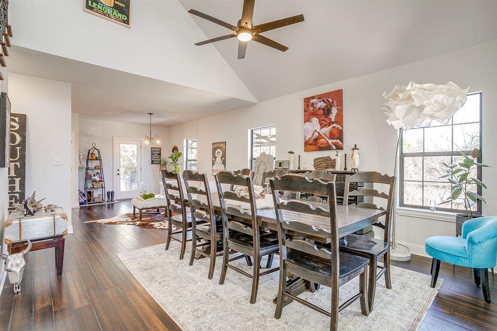 4920 Shining Star Trail Rio Vista, TX 76093 - Photo 12 of 40 a view of a dining room and livingroom with furniture wooden floor a chandelier