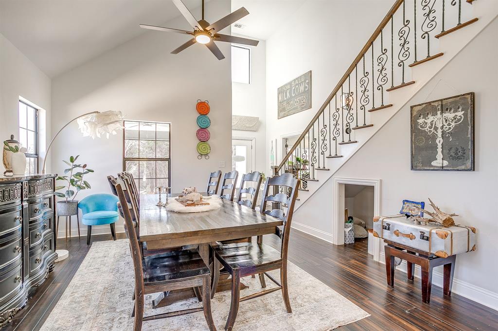 4920 Shining Star Trail Rio Vista, TX 76093 - Photo 14 of 40 a dining room with wooden floor a chandelier a wooden table and chairs